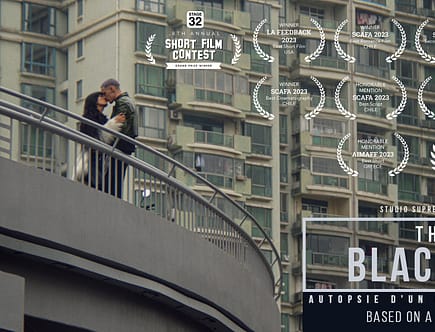 Sai (played by Xinwen Cui) and Thibaut Royer, the lead actors of 'The Black Box,' share a tender kiss with the bustling skyline of Shanghai in the background, capturing a poignant moment of connection amidst the vibrant cityscape.